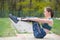 Portrait of a young happy woman doing exercises for the abdomen