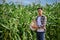 Portrait of young hardworking male farmer working in his corn field