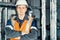 Portrait of young heavy industry engineer in protective vest and work clothes and helmet. Confident worker