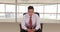 Portrait of young Hispanic business professional sitting in office chair looking at camera