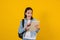 Portrait of young hispanic child teen girl student with digital tablet on yellow background in Mexico Latin America