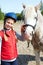 Portrait of young horsewoman and brown horse.