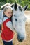 Portrait of young horsewoman and brown horse.