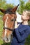 Portrait of young horsewoman and brown horse.