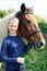 Portrait of young horsewoman and brown horse.