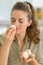 Portrait of young housewife smelling mushroom