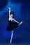 Portrait of young incredibly beautiful woman, ballerina in black ballet outfit, tutu dancing at blue studio full of