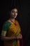 Portrait of young Indian Bengali brunette woman in Indian traditional wear sari