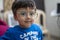 Portrait of a young indian infant kid with innocent eyes. happy and freedom concept. Wearing large glasses