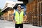 Portrait of young Indian worker working in logistic industry outdoor in front of factory warehouse. Smiling happy man