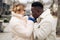 Portrait of young interracial couple holding each other hands on street