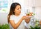 Portrait of young latino woman with fresh salad