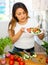 Portrait of young latino woman with fresh salad