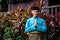 A portrait of young malay man in his traditional teal cloth, samping songket and songkok. Selamat Hari Raya gesture