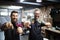 Portrait of young male barbers and hairdressers in barber shop