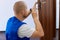 Portrait Young Male Carpenter Repairing Door Lock