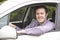 Portrait Of Young Male Driver Looking Out Of Car Window