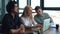 Portrait of young male and female startup business colleagues having discussion at desk looking at laptop screen in