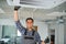 Portrait of young male indian technician repairing air conditioner. Air conditioner repairs.