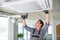 Portrait of young male indian technician repairing air conditioner. Air conditioner repairs.