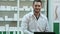 Portrait of young male pharmacist looking at camera and smiling