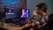 Portrait of young man in casual closing sitting at the desk working on pc editing video, drinking coffee during work.