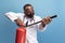 Portrait of young man, doctor, therapeutic or medical advisor with extinguisher  on blue background. Funny meme