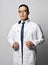 Portrait of young man doctor urologist or proctologist in glasses, medical gown uniform, white shirt and tie