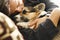 Portrait of young man embracing his pet. Cute Welsh Corgi puppy resting with owner, spending time together at home.