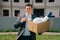 Portrait of a young man, European holding a box with things in his hands, leaving the office