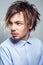 Portrait of young man with fringe messy hairstyle. studio shot