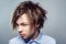 Portrait of young man with fringe messy hairstyle. studio shot