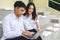 Portrait of young man and girl in university uniform sitting and working on laptop.