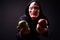Portrait of young man with hoodie and horror mask holding apples
