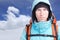 Portrait of young man mountaineer in the winter mountains. Blue sky and white clouds