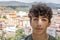 Portrait of young man with an old mountain village in the background