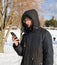 Portrait of young man with phone in winter park