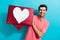 Portrait of young man popular blogger brunet hair guy holding red symbol heart collage click like isolated on aquamarine