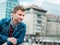 Portrait of young man posing on the street, profile of handsome guy