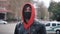 Portrait of young man in protective mask standing outdoors, seasonal flu epidemic in country.