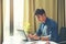 Portrait of young man sitting at his desk in the office