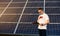 Portrait of a young man by solar panels