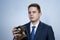 Portrait of a young man in a suit with an old camera, perhaps he is a novice journalist doing a report, a diplomat or secret