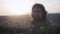 Portrait of a young man at sunset. Long curly hair