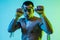 Portrait of young man thai boxer training over blue background.