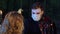 Portrait of young man in vampire costume with face paint in coronavirus face mask celebrating Halloween night with