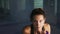 Portrait of a young martial arts female athlete shadow boxing looking in the camera training in a dark room with smoke