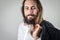 Portrait of a young middle eastern businessman with beard and long hair holding his jacket over his shoulder