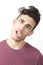 Portrait of young Middle Eastern man making funny faces over white background