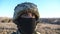 Portrait of young military man in helmet and balaclava at countryside. Sight of male ukrainian army soldier outdoor